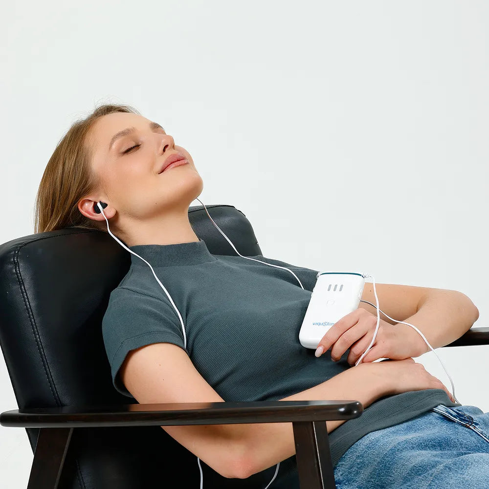 Woman relaxing in a chair during a Vagustim session